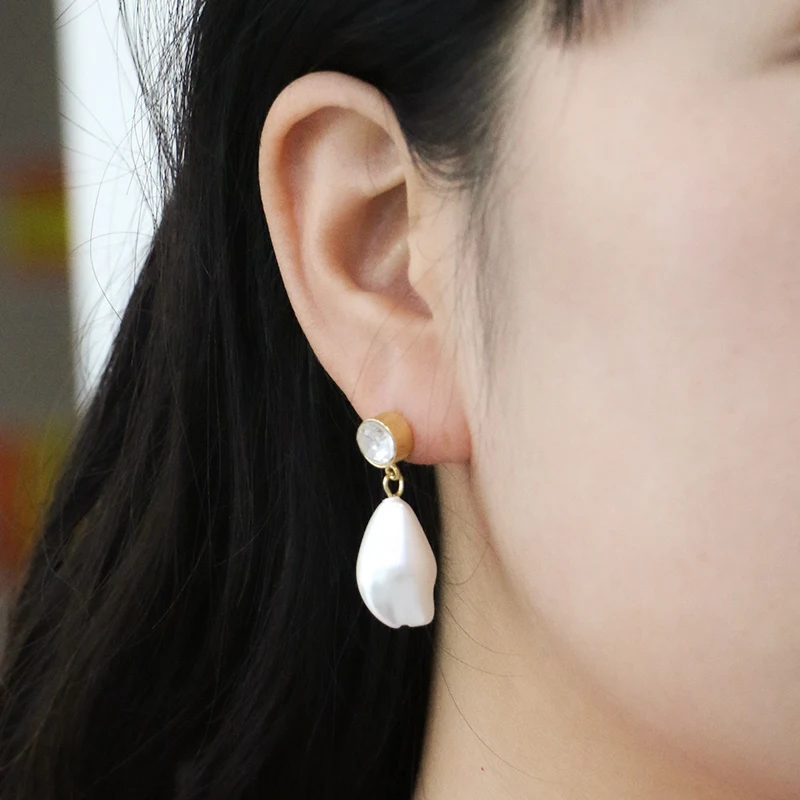 A faux Baroque pearl smile face earrings
